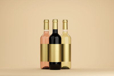 Close-up of wine bottles against white background