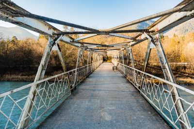 Steel bridge over the river in the mountains at morning