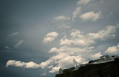 Low angle view of built structure against cloudy sky