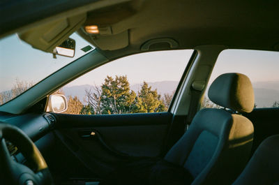 Man seen through car windshield