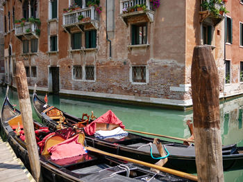 Group of traditional gondolas moored on narrow canal in venice