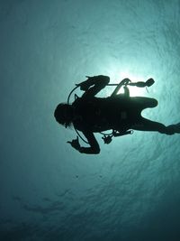 Woman scuba diving in sea.