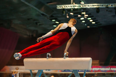 Side view of woman exercising in gym