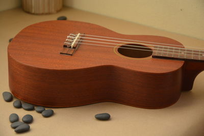 Close-up of guitar and pebbles on table