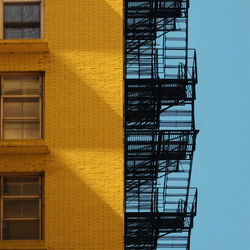 Low angle view of yellow staircase against building