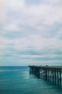 Pier over sea against sky