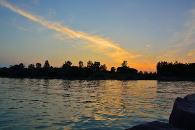 Scenic view of lake against sky during sunset