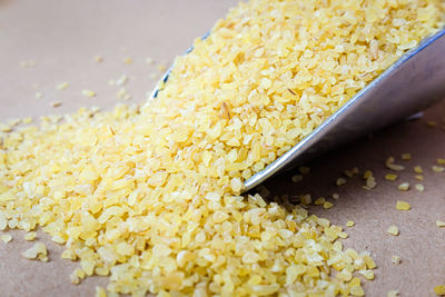 High angle view of yellow container on wood