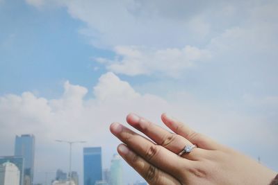 Cropped image of hand against sky