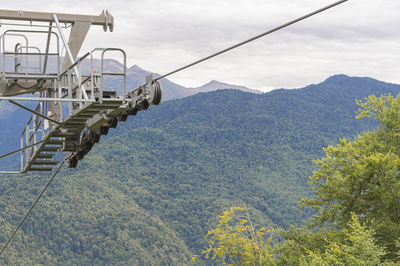 Lifts of the mountain cable car on the background of mountains