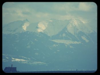 Scenic view of mountains against cloudy sky