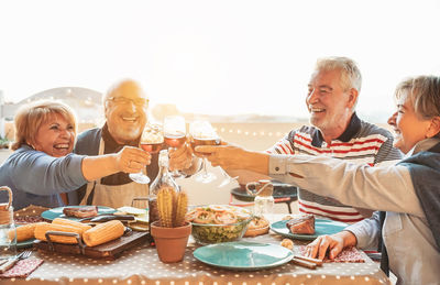 Senior couples toasting wineglasses