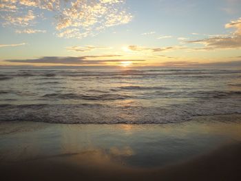 Scenic view of beach against sky during sunset