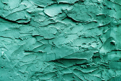 Uneven rough green-turquoise texture. texture of green-turquoise rough wall surface. 