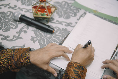 Cropped hands of man working on table