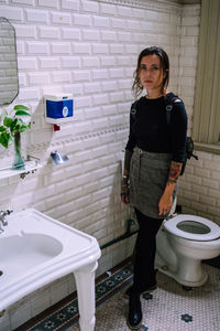 Portrait of woman standing in bathroom