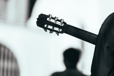 Close-up of man playing guitar