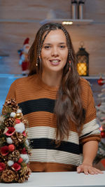 Portrait of young woman at home during christmas