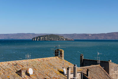 High angle view of sea against clear blue sky