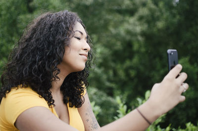 Portrait of young woman using mobile phone