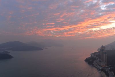 View of sea against cloudy sky during sunset