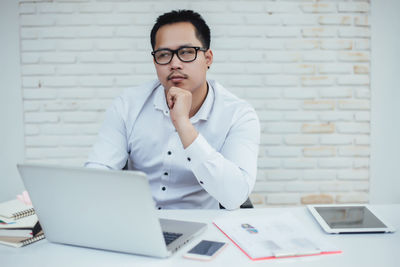 Mid adult man using laptop on table