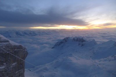 Scenic view of snowcapped mountains against sky during sunset
