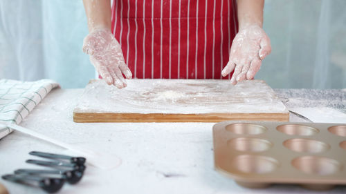 Midsection of person preparing food on table