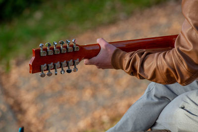 Guitar resting on the table among the leaves