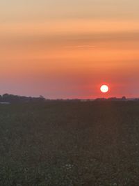 Scenic view of field against sky during sunset