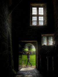 Man seen through archway