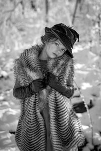 Portrait of young woman wearing warm clothing standing outdoors