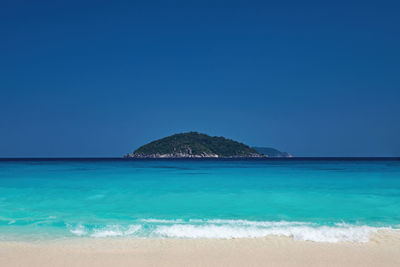 Scenic view of sea against clear blue sky