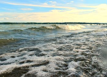 Waves rushing towards shore during sunset