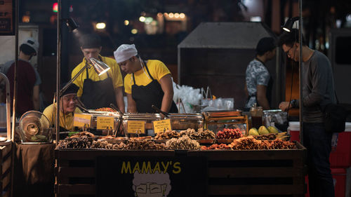 People working at market stall