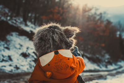 Rear view of woman in winter