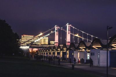 Bridge over river in city at night