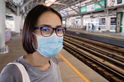 Portrait of woman at railroad station