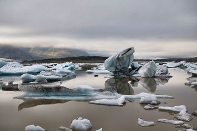 Frozen lake against sky during winter