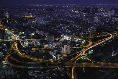 High angle view of illuminated buildings in city at night