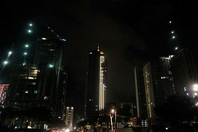 Low angle view of skyscrapers lit up at night