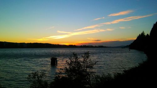 Scenic view of calm lake at sunset