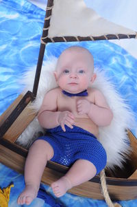 Portrait of cute baby girl sitting in swimming pool