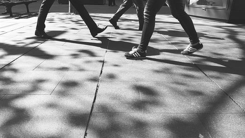 Low section of people walking on road