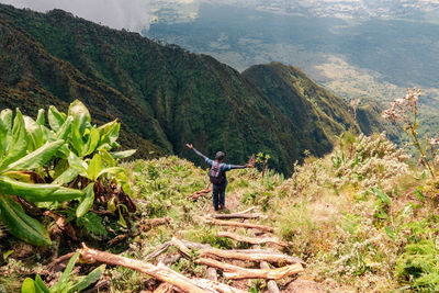 A hiker on a ladder at mount sabyinyo in the mgahinga gorilla national park, virungas region, uganda