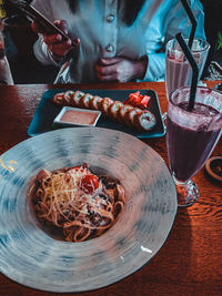 Midsection of food in glass on table at restaurant