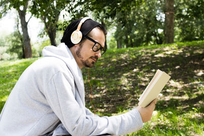 Side view of young man wearing hat