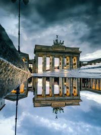 Low angle view of historical building against cloudy sky