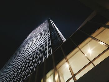 Low angle view of illuminated building against sky at night