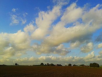 Scenic view of landscape against cloudy sky